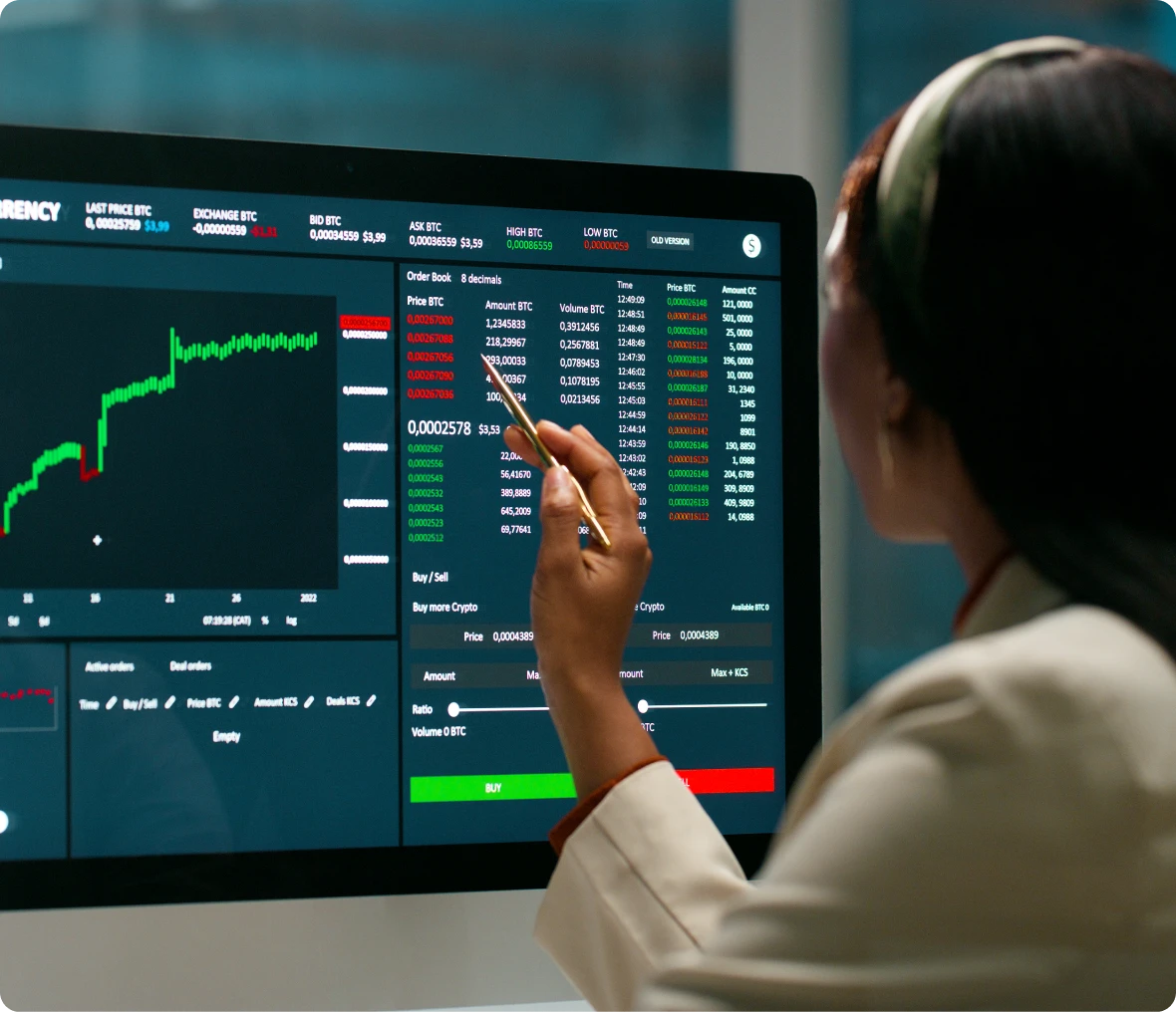 Woman pointing at stock market charts.